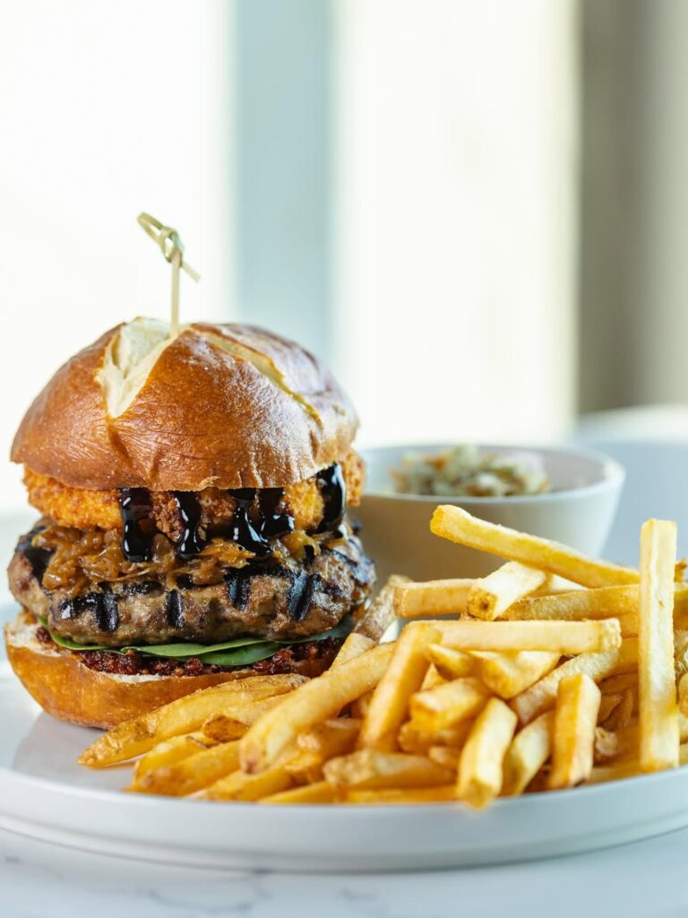 Burger on a pretzel bun, french fries and salad from Kingscoast Estate winery