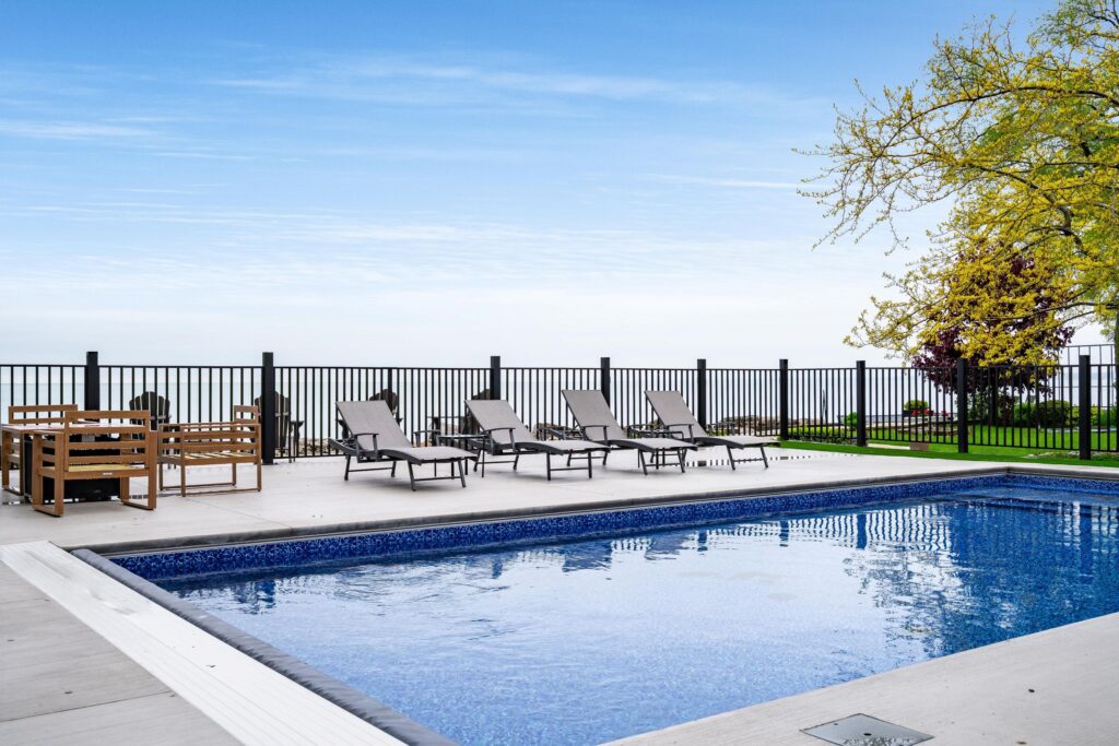 Vogue Vista Lake Estate poolside with views of Lake Erie and a water's edge deck